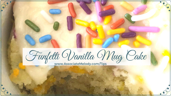 funfetti vanilla mug cake with vanilla frosting and rainbow sprinkles